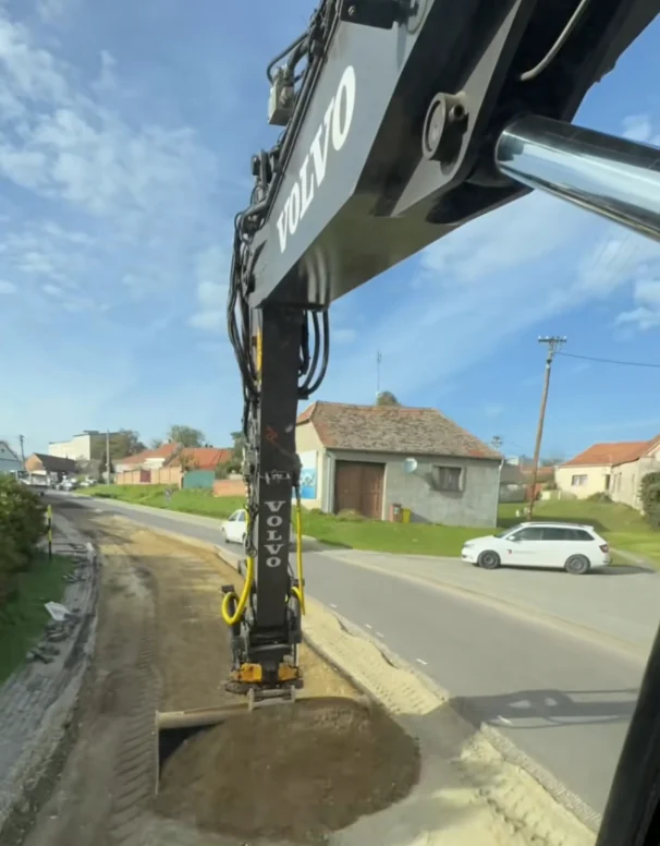 Excavator bucket working beside a road